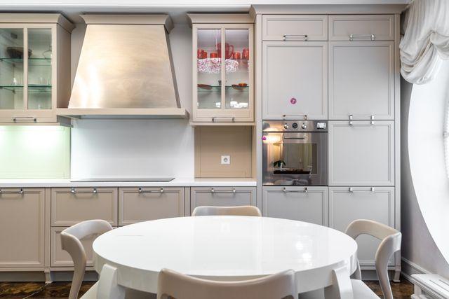 a neutral kitchen with a round white table